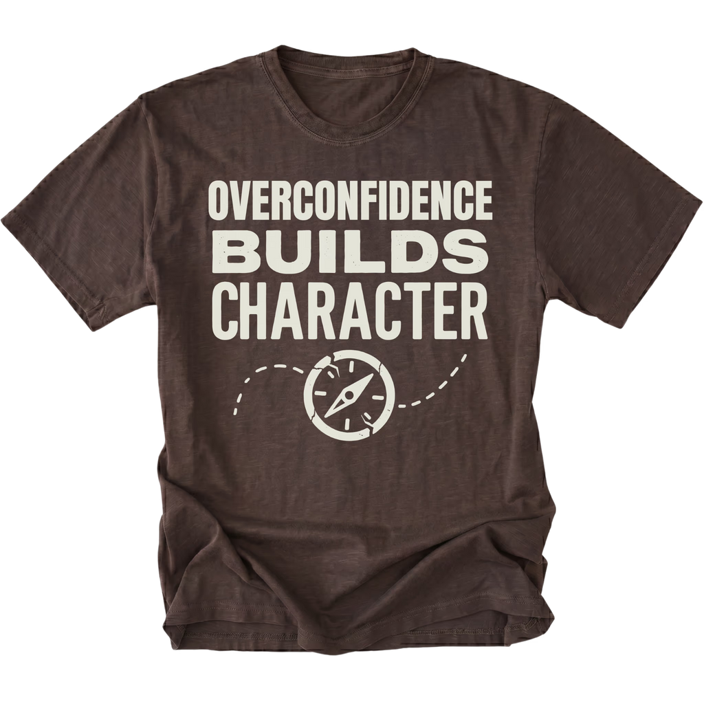 Espresso T-Shirt with “Overconfidence Builds Character” text and compass graphic shown on front view by Trail Snark.