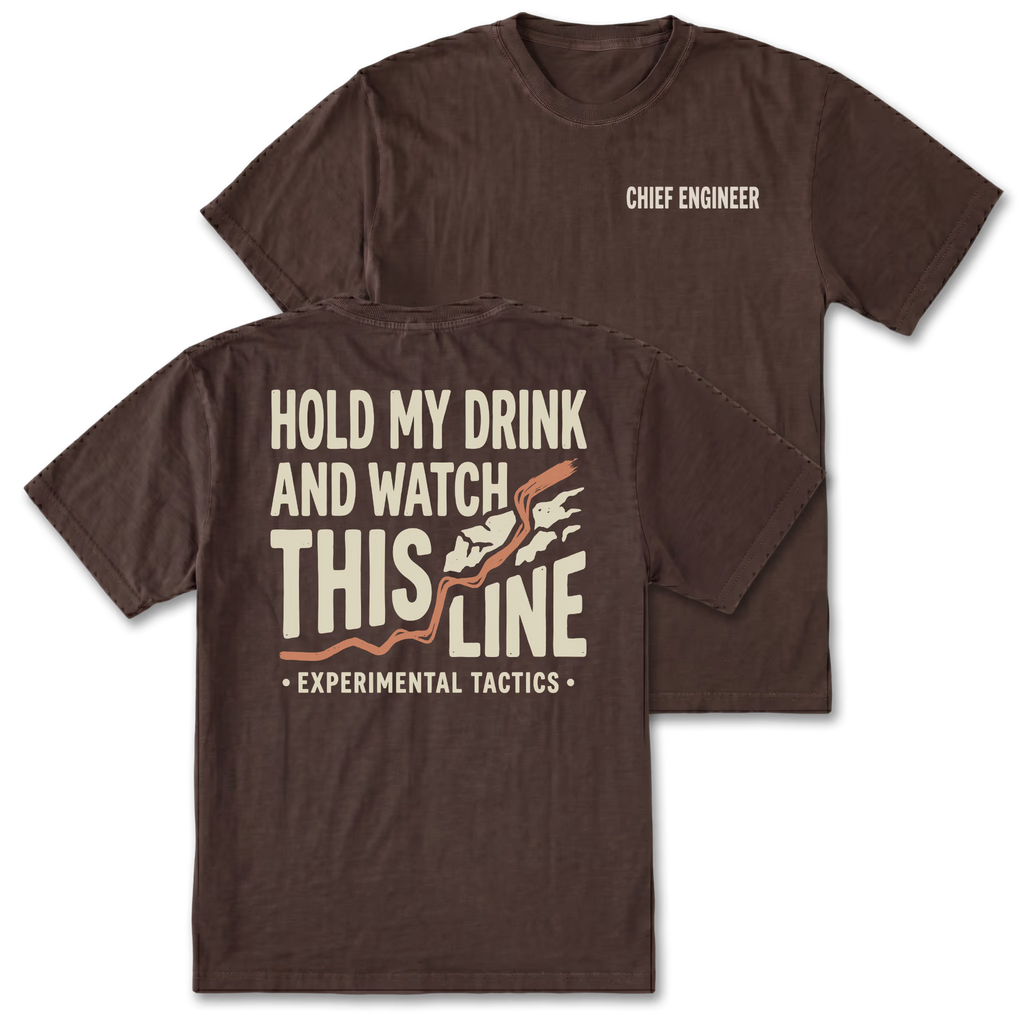 Two dark brown t-shirts shown on a white background, displaying both the front and back designs. The front shirt features the text 'CHIEF ENGINEER' in white on the left chest. The back features the text 'HOLD MY DRINK AND WATCH THIS LINE' and smaller text 'EXPERIMENTAL TACTICS' under.
