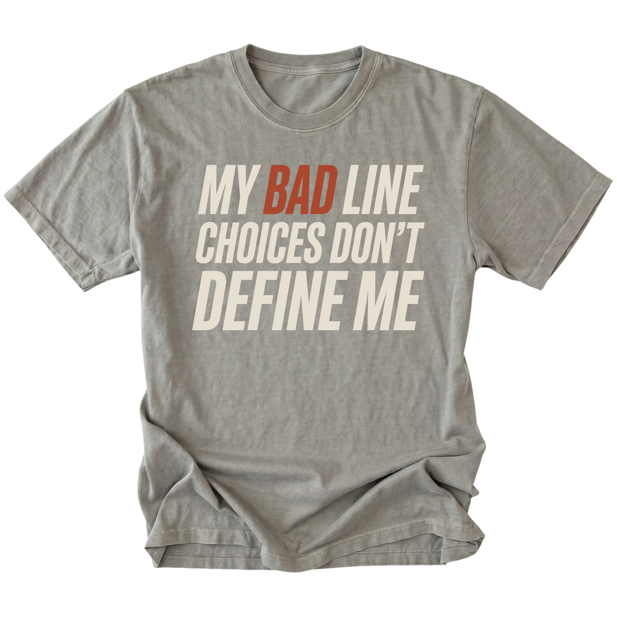 Grey crewneck T-shirt shown from the front with large slanted off-white lettering reading "MY BAD LINE CHOICES DON'T DEFINE ME"; "BAD" is highlighted in rust orange.