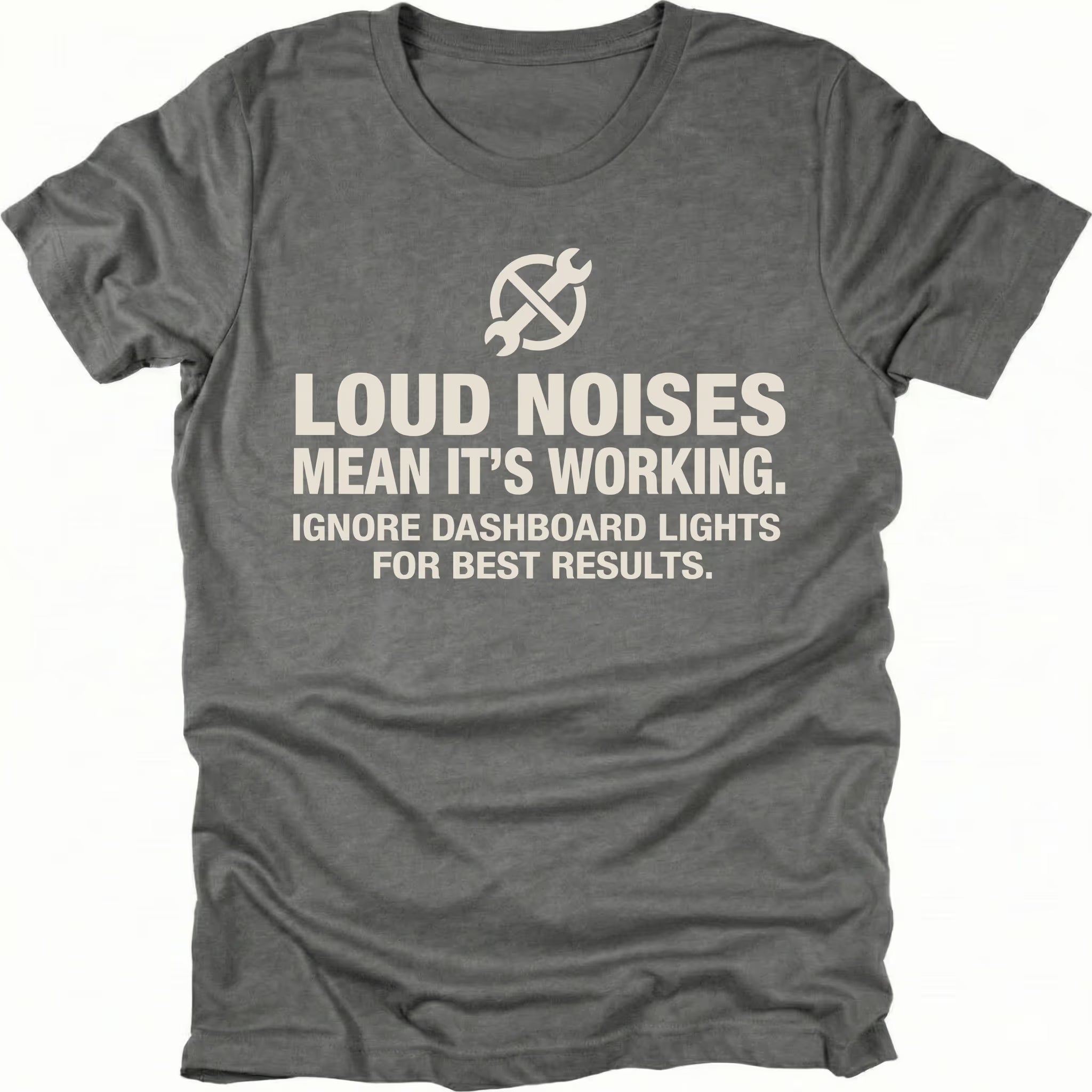 Grey t-shirt with wrench icon and text reading Loud Noises Mean It’s Working Ignore Dashboard Lights for Best Results, front view by Trail Snark.