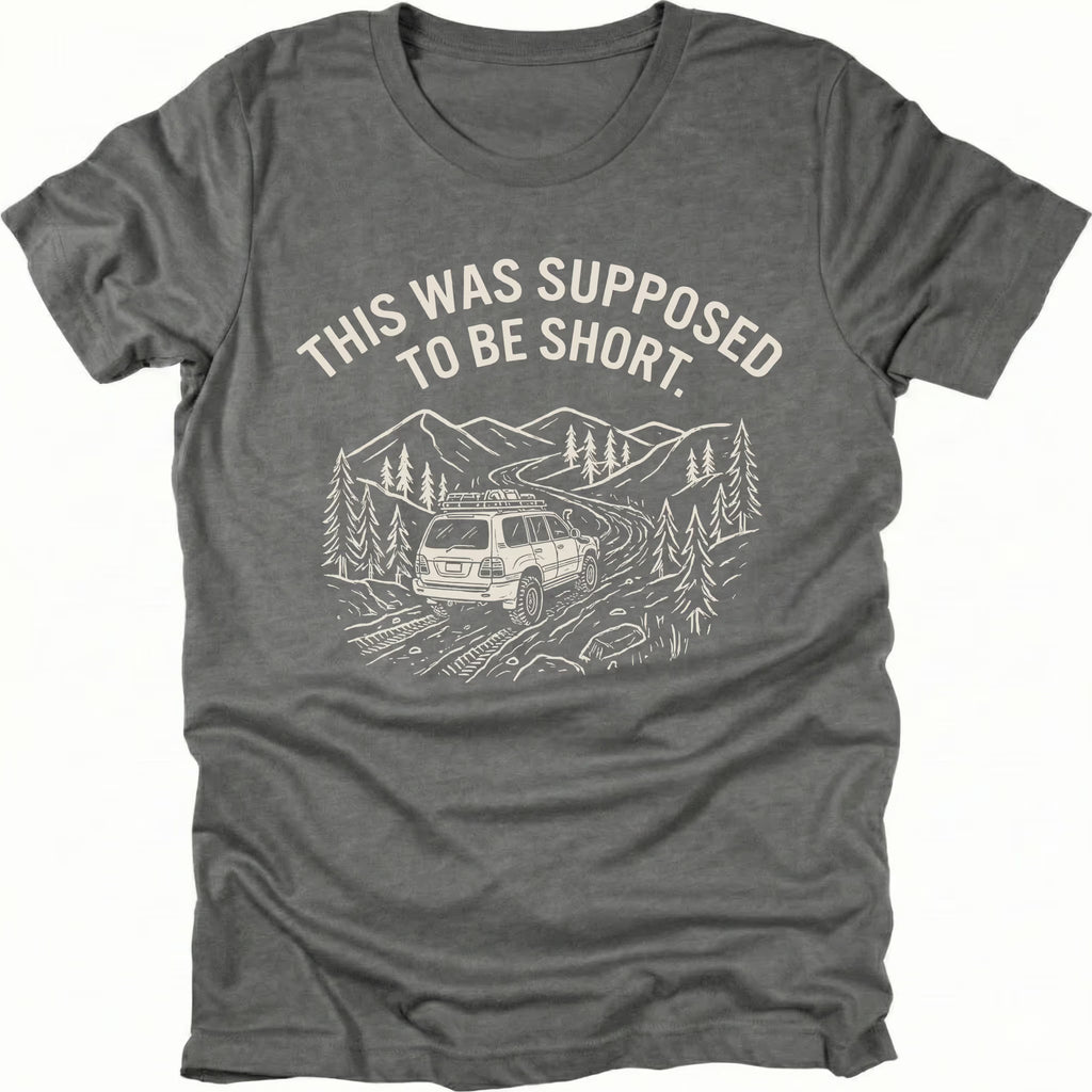 Grey t-shirt with text reading “This Was Supposed to Be Short” above an illustration of an SUV driving a winding forest trail through mountains.