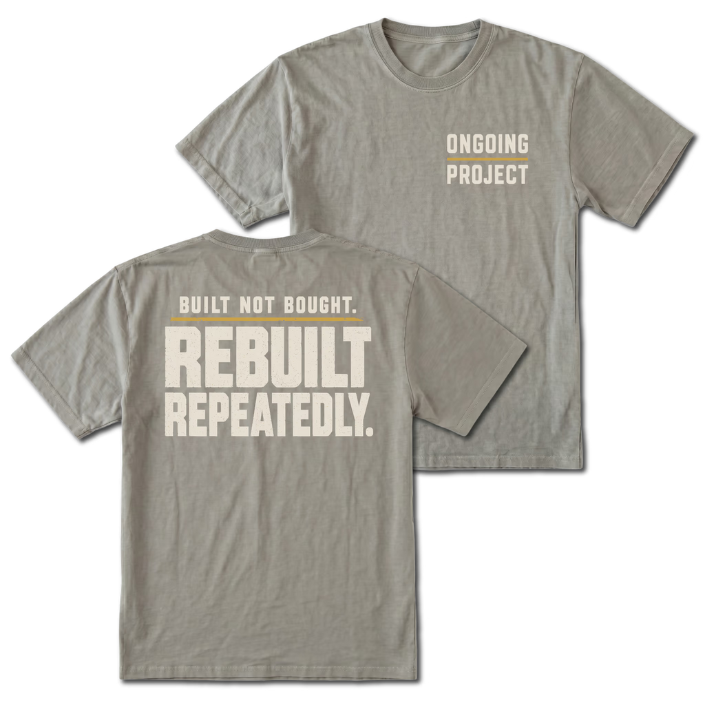 Grey T-Shirt with Ongoing Project front design and Built Not Bought Rebuilt Repeatedly back design shown by Trail Snark.