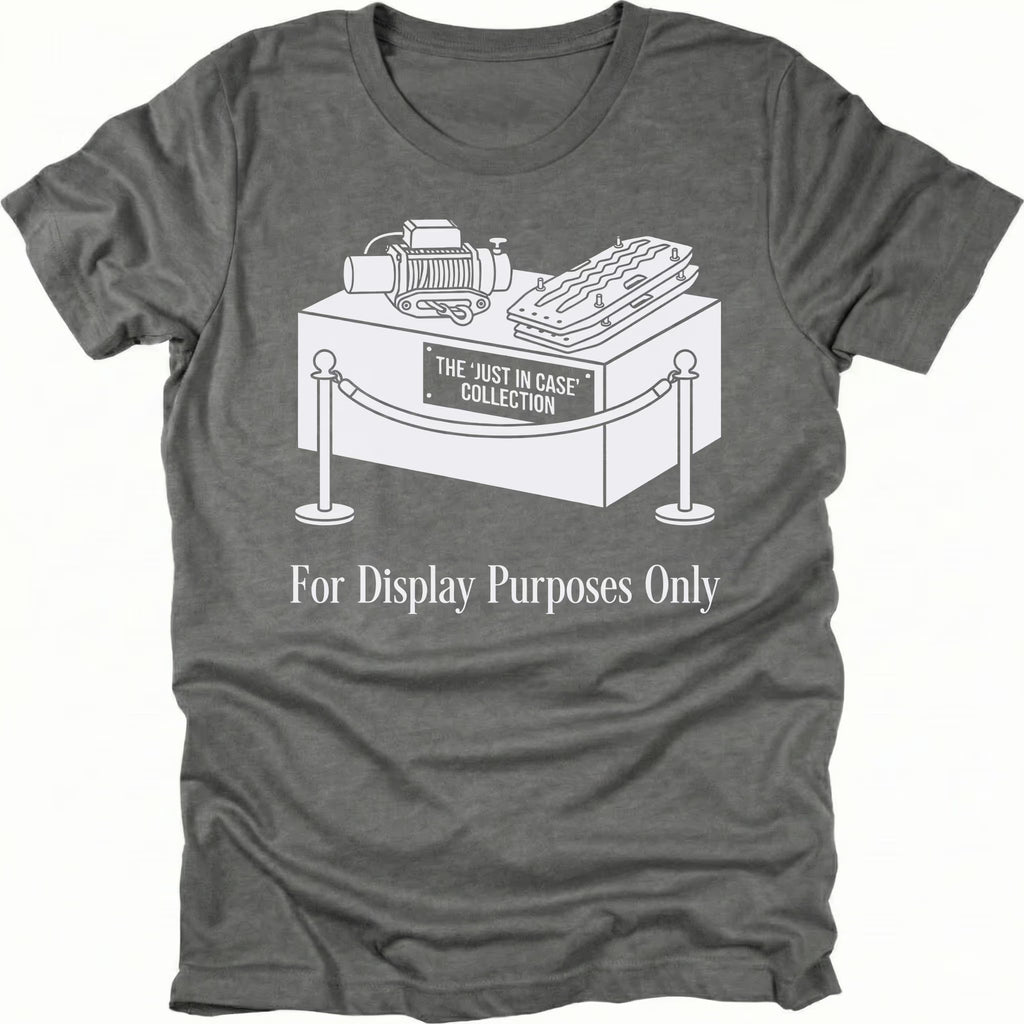 Grey t-shirt featuring a display stand graphic labeled the just in case collection with off-road gear and for display purposes only text shown from the front.
