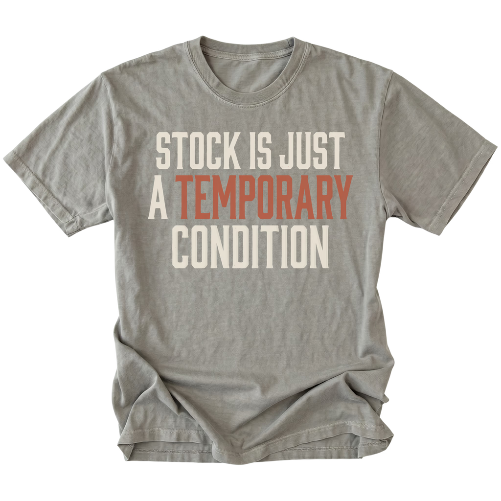 A gray short-sleeve t-shirt with a distressed graphic text print reading 'STOCK IS JUST A TEMPORARY CONDITION' in cream and muted orange-red lettering, displayed flat against a solid white background.