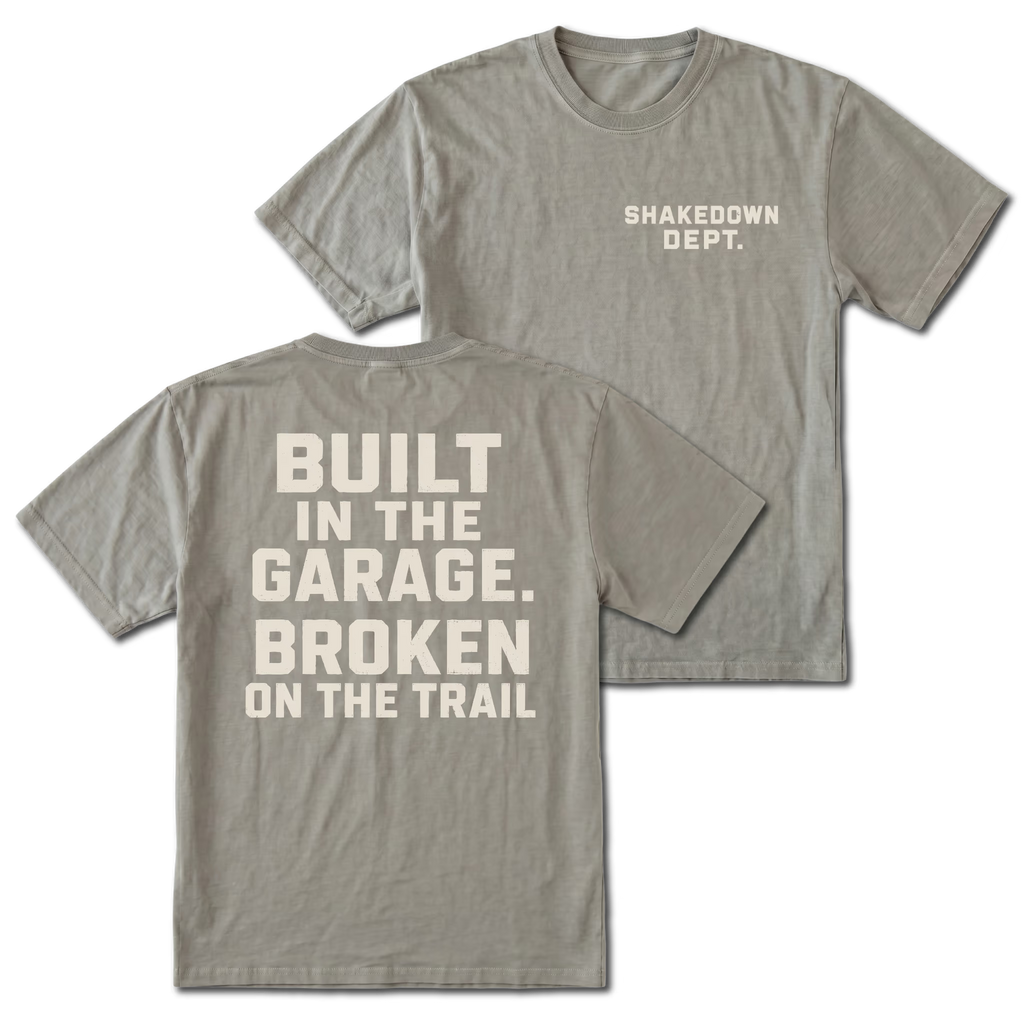 Grey T-shirt with Shakedown Dept front print and Built in the Garage Broken on the Trail back design shown front and back by Trail Snark.