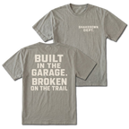 Grey T-shirt with Shakedown Dept front print and Built in the Garage Broken on the Trail back design shown front and back by Trail Snark.