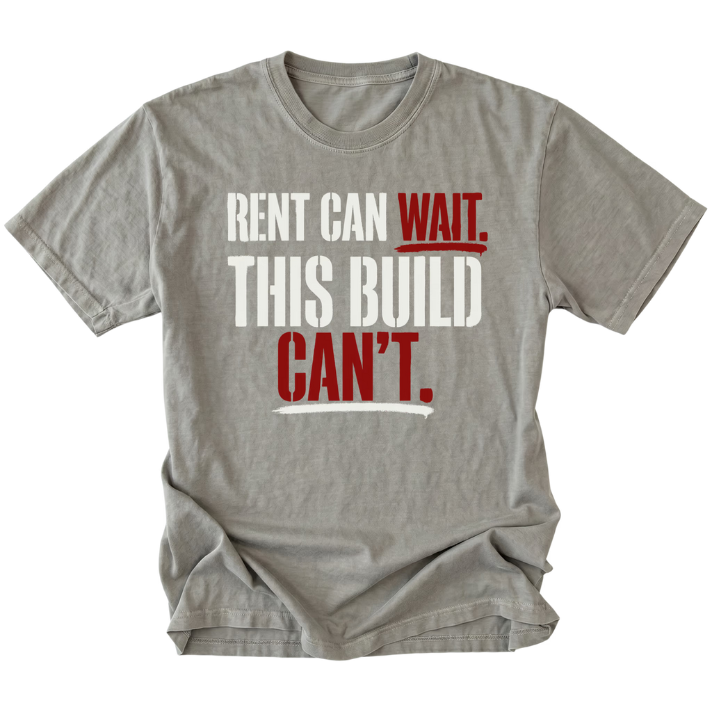 Grey T-Shirt featuring Rent Can Wait This Build Can't text design in bold typography on front view by Trail Snark.