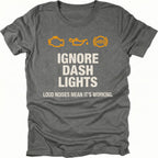 Grey t-shirt with dashboard warning icons and the text Ignore Dash Lights Loud Noises Mean It’s Working, front view by Trail Snark.