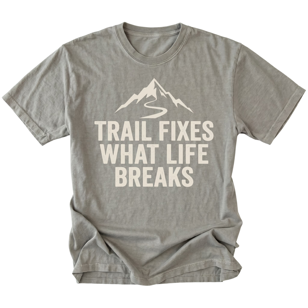 Grey t-shirt with the phrase “Trail Fixes What Life Breaks” beneath a mountain and winding trail graphic printed on the front.
