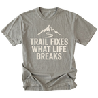 Grey t-shirt with the phrase “Trail Fixes What Life Breaks” beneath a mountain and winding trail graphic printed on the front.