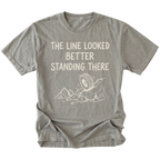 Grey T-Shirt with hand-drawn tire and rocks graphic and text reading “The Line Looked Better Standing There” shown on front view by Trail Snark.