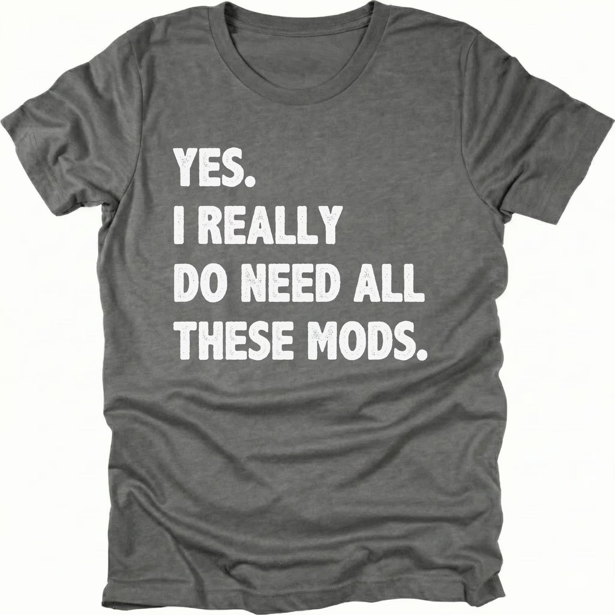 Grey t-shirt with bold white text reading “Yes I Really Do Need All These Mods” displayed on the front by Trail Snark.