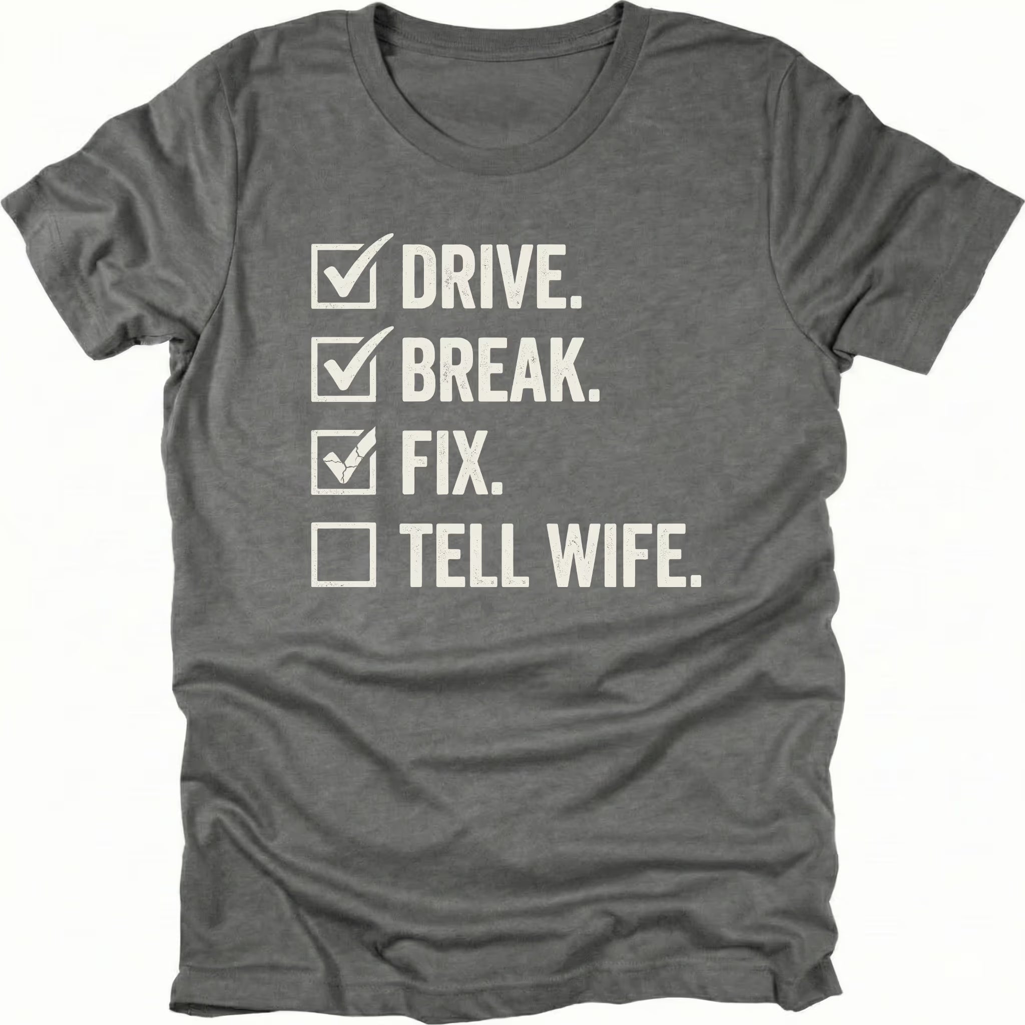 Grey t-shirt featuring drive break fix tell wife checklist text graphic shown from the front by Trail Snark.