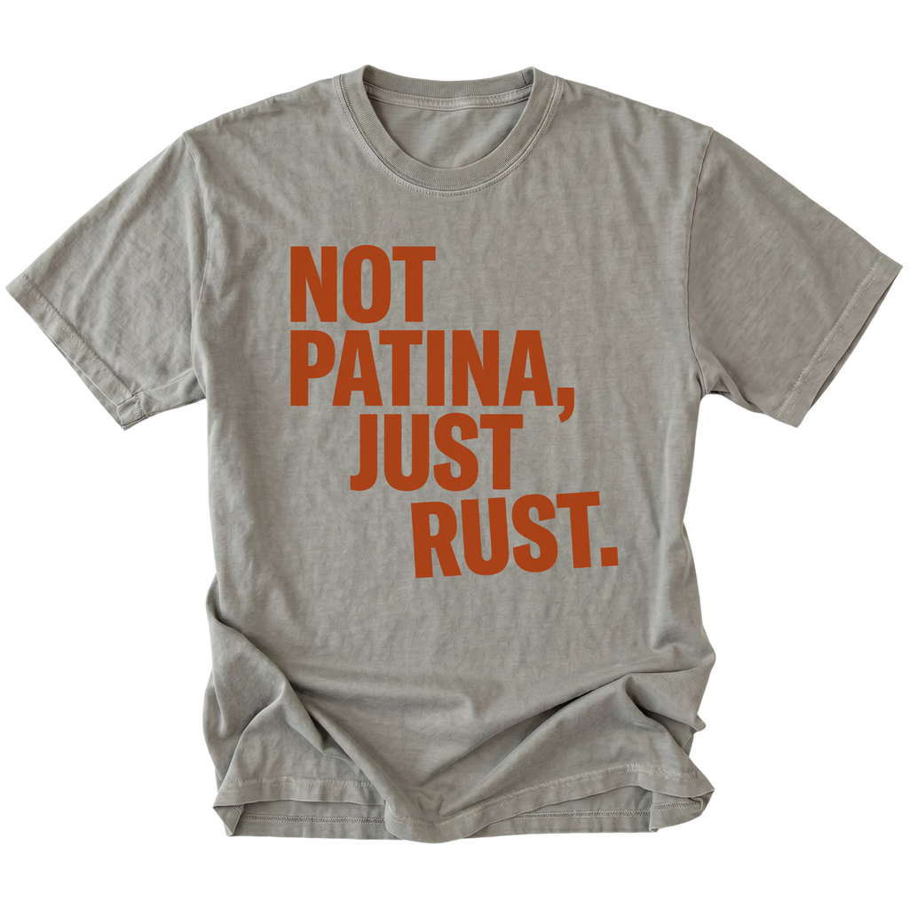Grey t-shirt with bold rust-colored text reading Not Patina, Just Rust on the front.