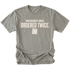 Grey T-shirt with a Measured Once Ordered Twice garage humor design shown from the front by Trail Snark.