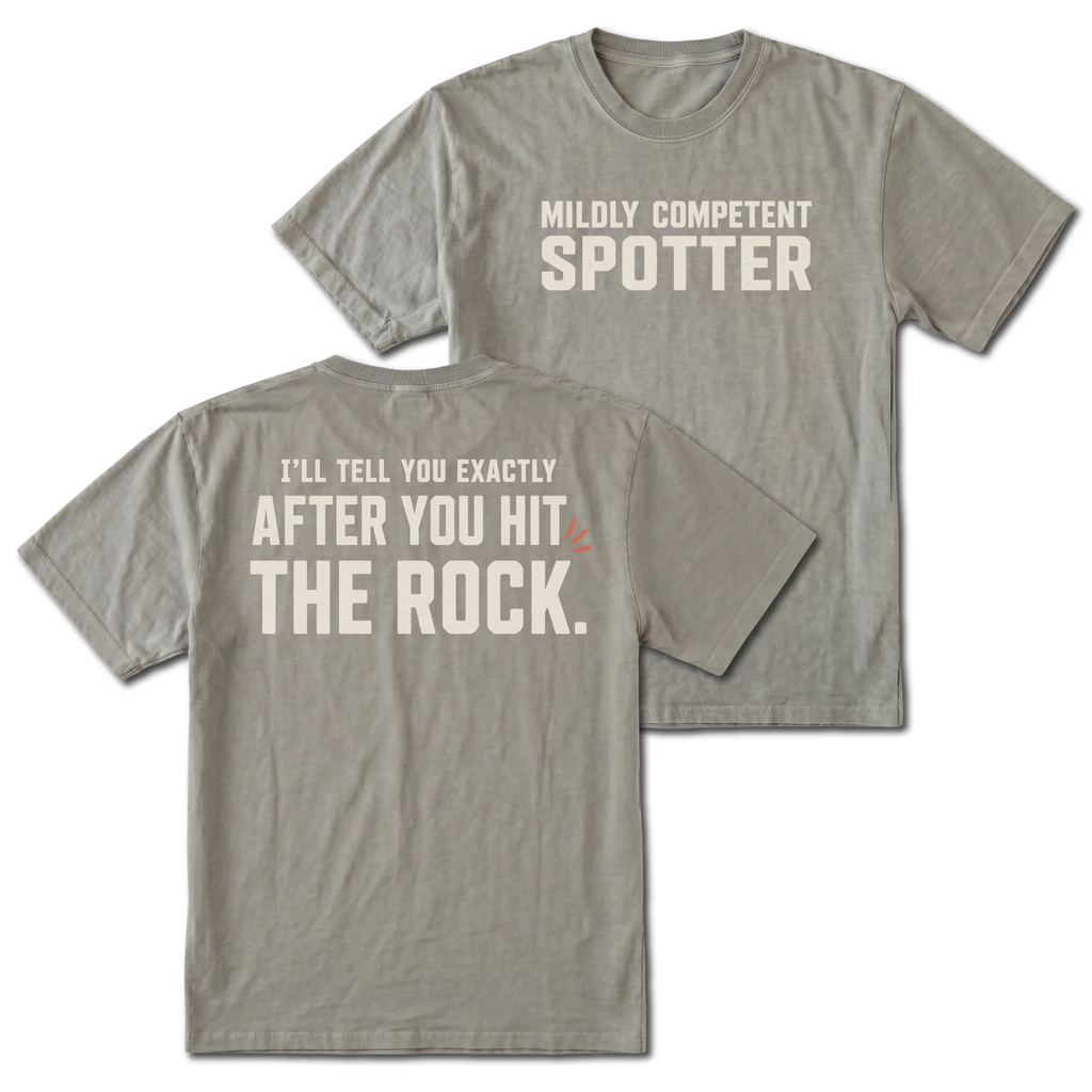 Grey t-shirt featuring the Mildly Competent Spotter design on the front and the after you hit the rock design on the back by Trail Snark.