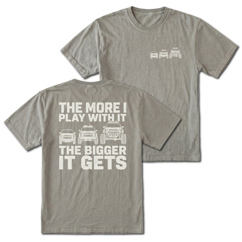 Grey T-shirt with The More I Play With It The Bigger It Gets truck build design shown from the back view by Trail Snark.