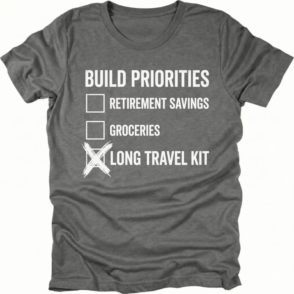 Grey T-Shirt featuring Build Priorities checklist highlighting long travel kit on front view by Trail Snark.