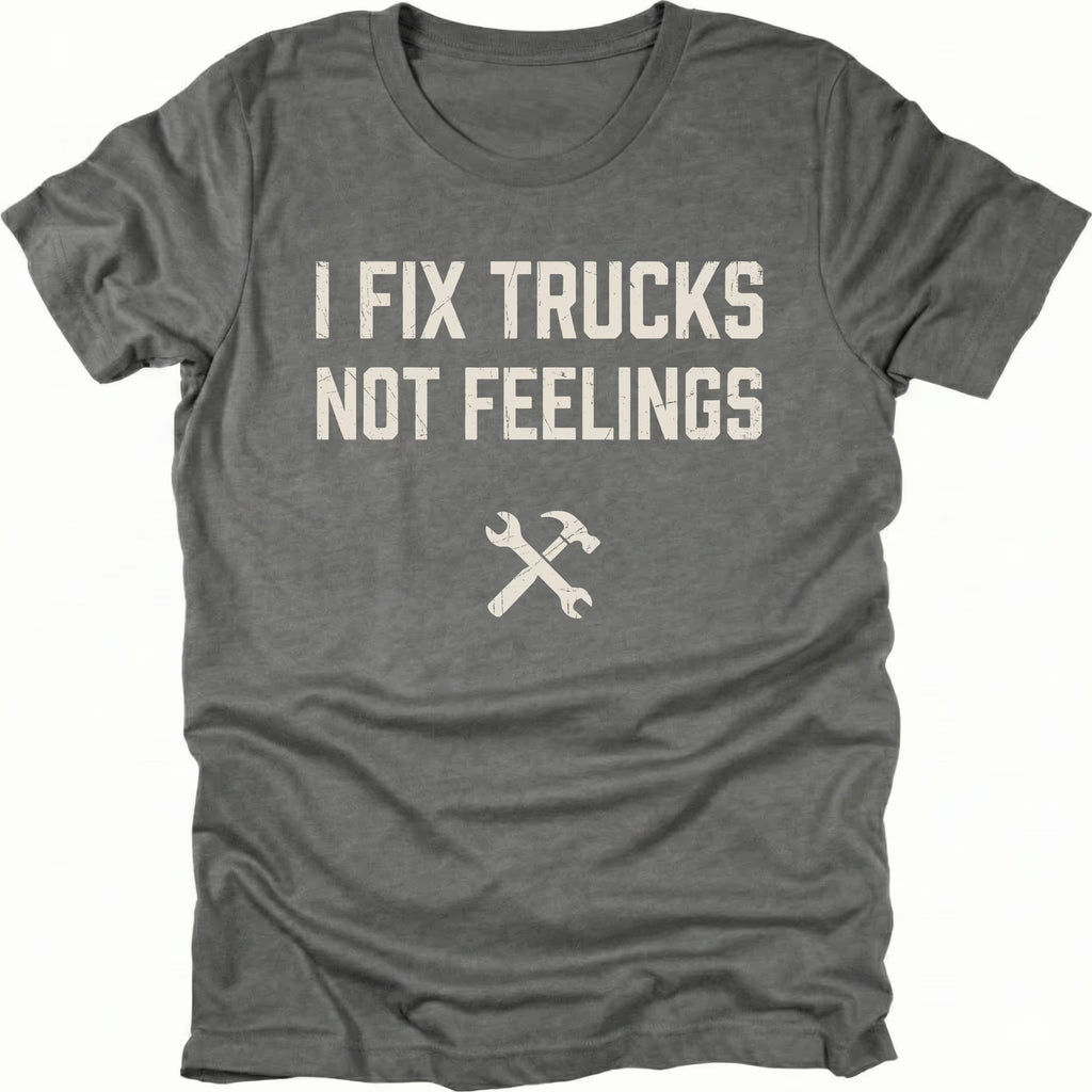 Grey t-shirt with bold distressed text reading I Fix Trucks Not Feelings and crossed wrench and hammer icon.
