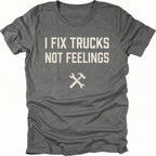 Grey t-shirt with bold distressed text reading I Fix Trucks Not Feelings and crossed wrench and hammer icon.