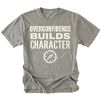 Grey T-Shirt with “Overconfidence Builds Character” text and compass graphic shown on front view by Trail Snark.