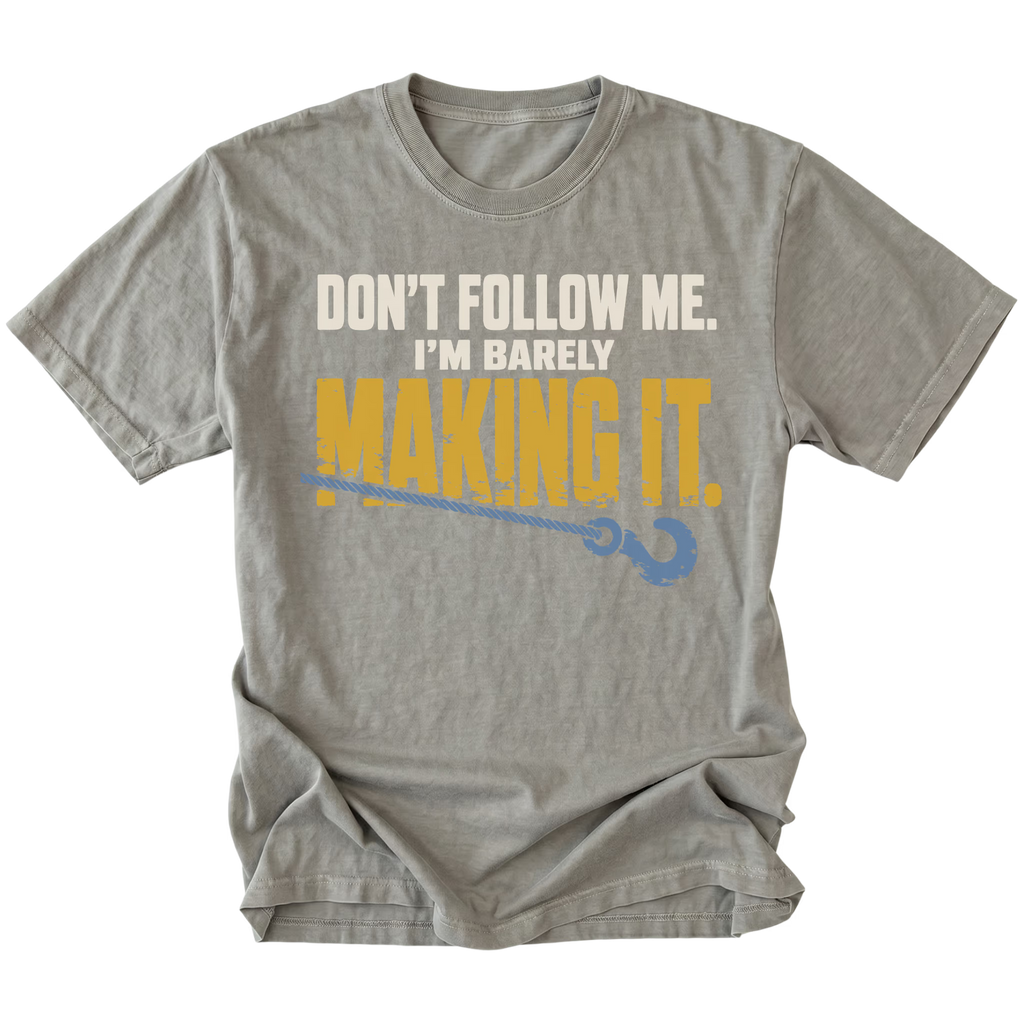 Grey T-shirt featuring the Barely Making It recovery hook design on the front by Trail Snark.