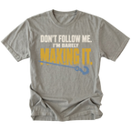 Grey T-shirt featuring the Barely Making It recovery hook design on the front by Trail Snark.