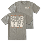 Two gray graphic t-shirts shown on a white background, with the front and back views overlapping. The front features a small 'BAD LINE ART' logo on the left chest, and the back features a large graphic print reading 'PROCEED WITH CONFIDENCE BAD LINES AHEAD RESULTS MAY VARY' in cream and orange lettering.