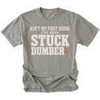 Grey t-shirt featuring the Stuck Dumber design on the front by Trail Snark.