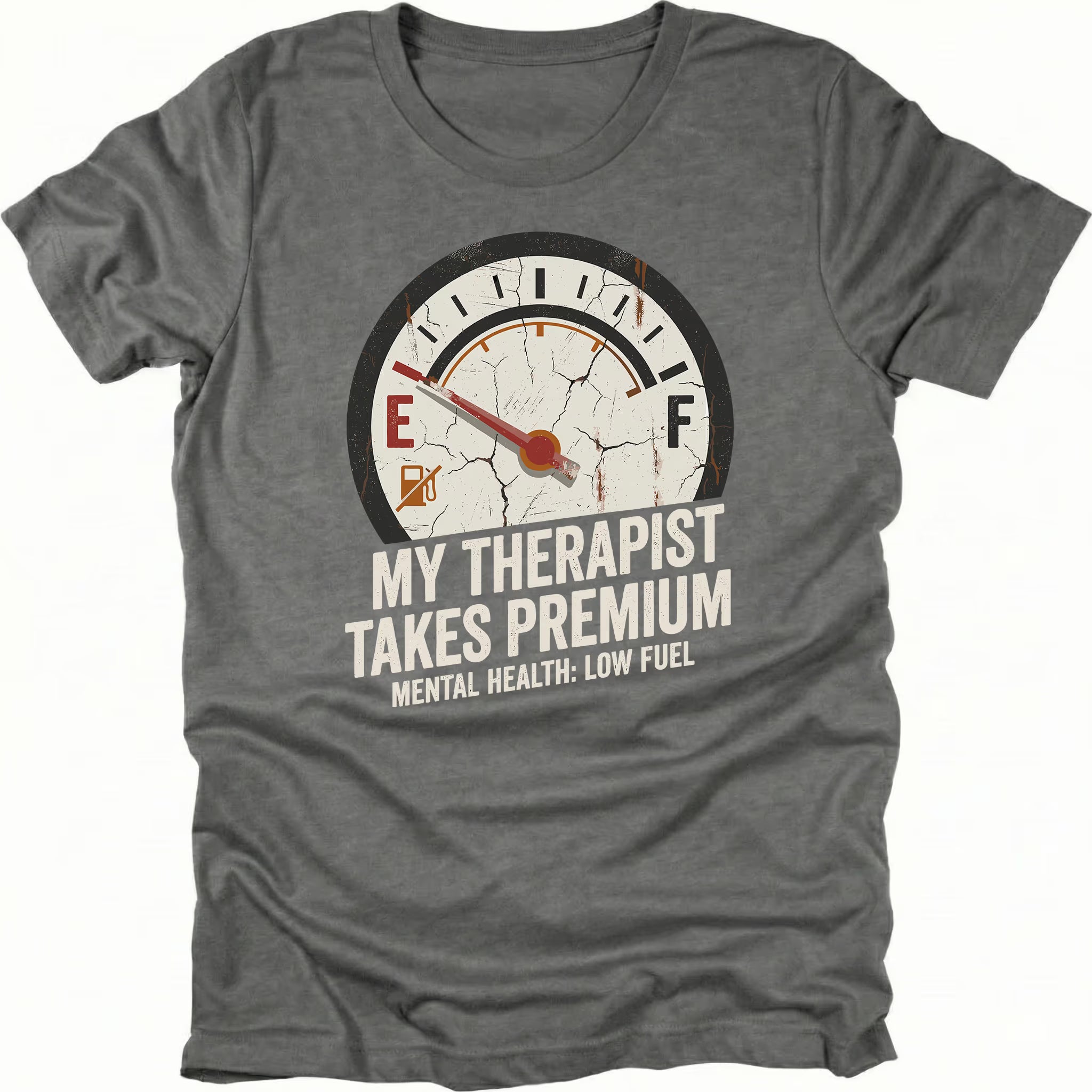 Grey t-shirt with distressed fuel gauge graphic pointing near empty and text reading My Therapist Takes Premium with Mental Health Low Fuel by Trail Snark.