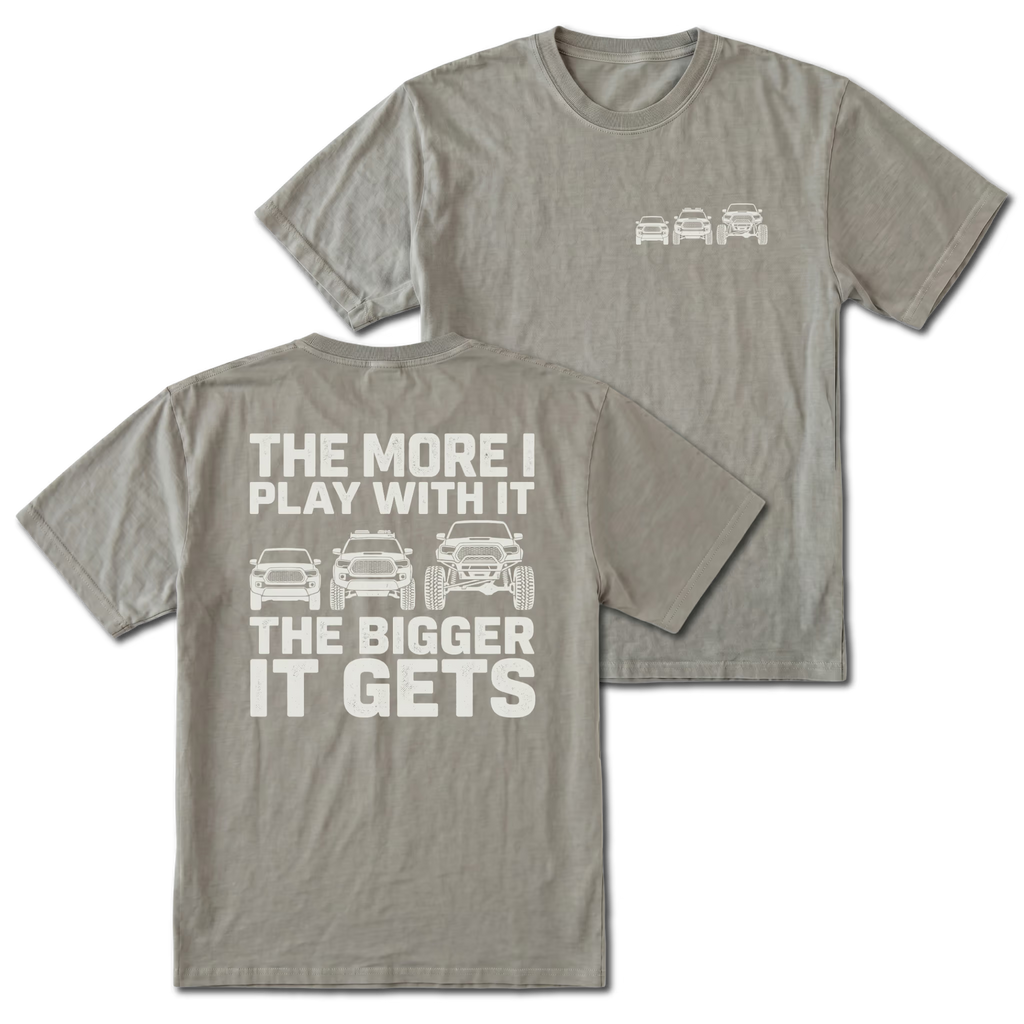 Grey T-shirt with The More I Play With It The Bigger It Gets truck build design shown from the back view by Trail Snark.