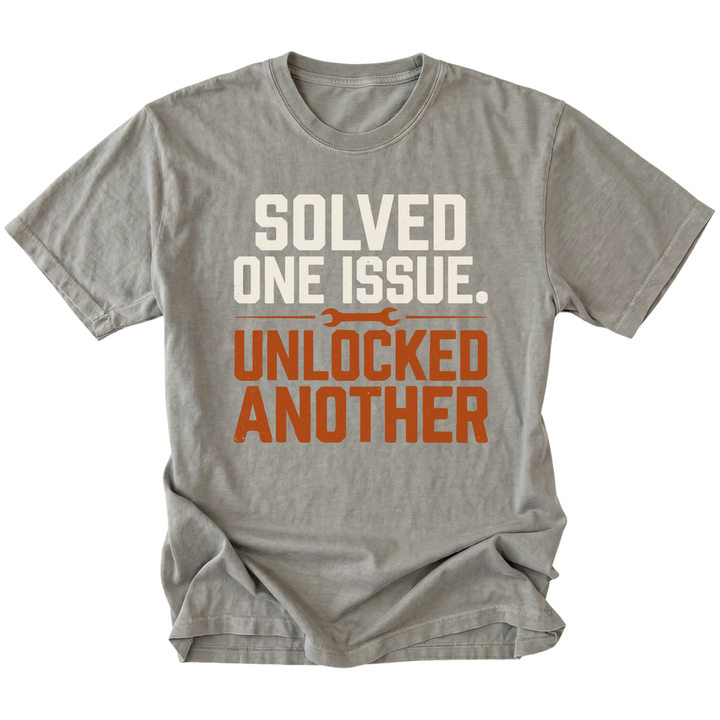 Grey T-Shirt with the Solved One Issue. Unlocked Another design shown in a front view by Trail Snark.