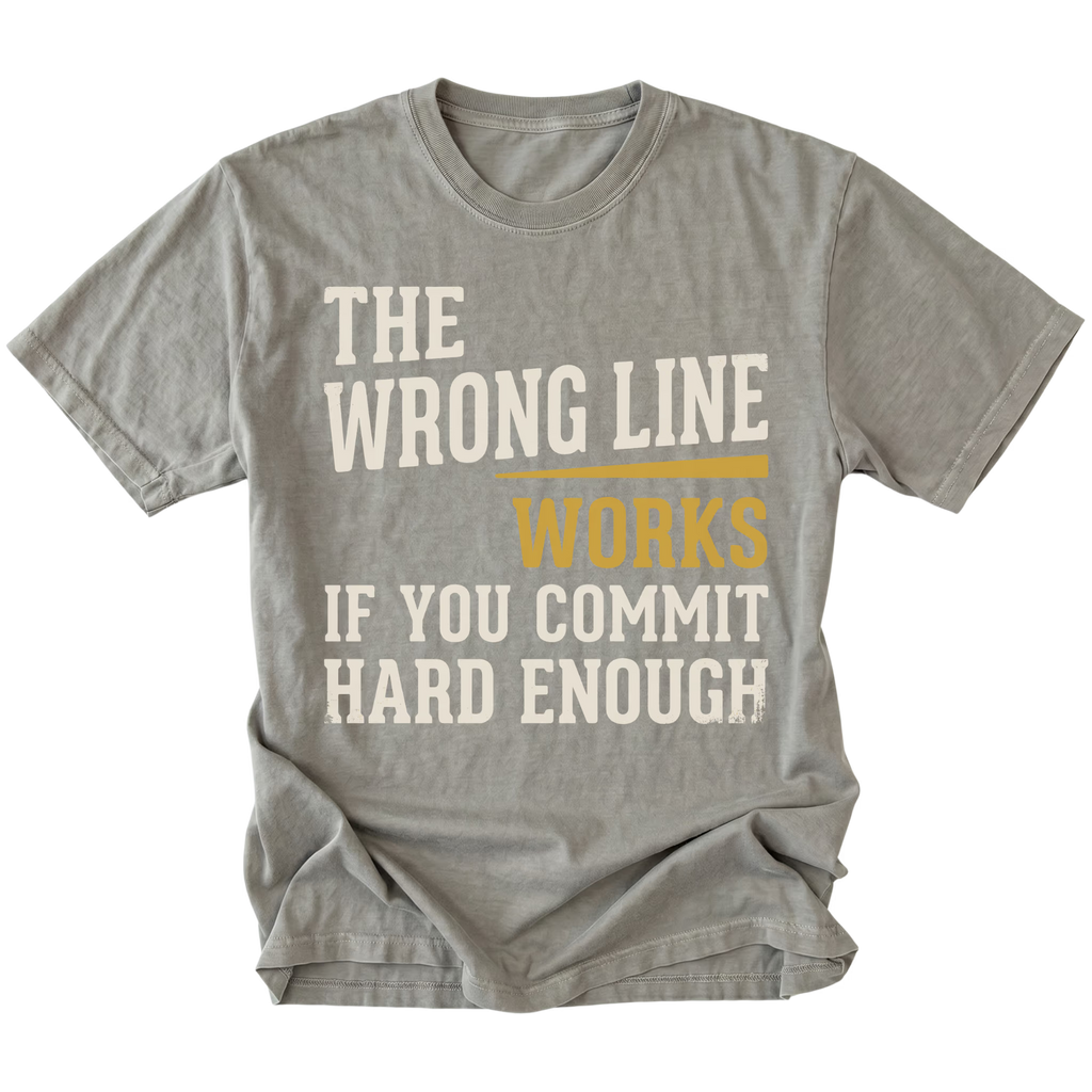 A gray heather crewneck t-shirt with a humorous text graphic reading 'THE WRONG LINE WORKS IF YOU COMMIT HARD ENOUGH' in distressed cream and mustard yellow lettering, shown on a plain white background.