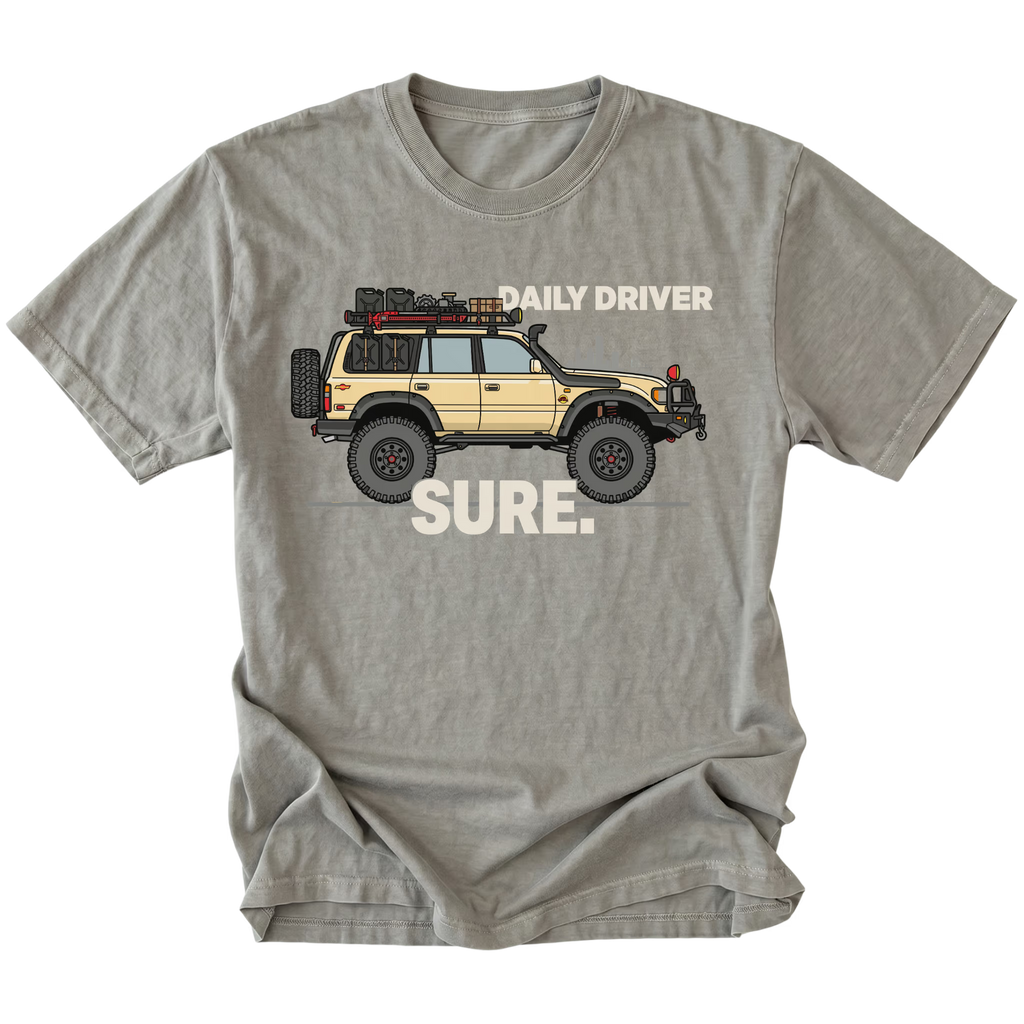 Grey t-shirt featuring a built off-road vehicle with daily driver sure text graphic shown from the front by Trail Snark.