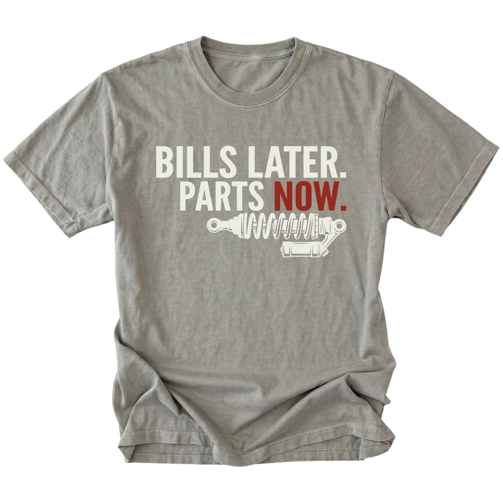 Grey t-shirt featuring Bills Later Parts Now design with suspension coilover graphic on front view by Trail Snark.