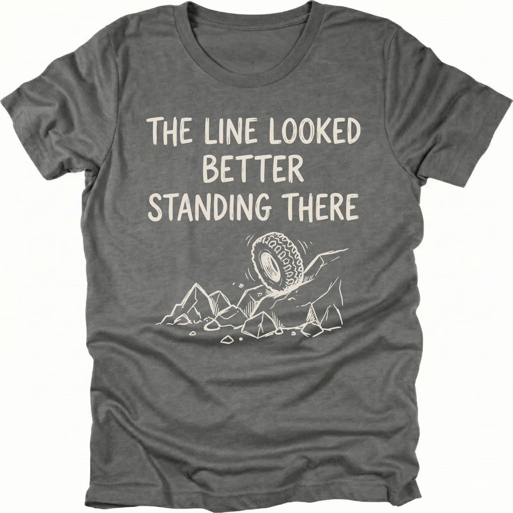 Grey T-Shirt with hand-drawn tire and rocks graphic and text reading “The Line Looked Better Standing There” shown on front view by Trail Snark.