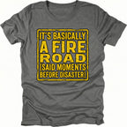 Grey t-shirt with yellow warning-style text reading Its Basically A Fire Road Said Moments Before Disaster, front view by Trail Snark.