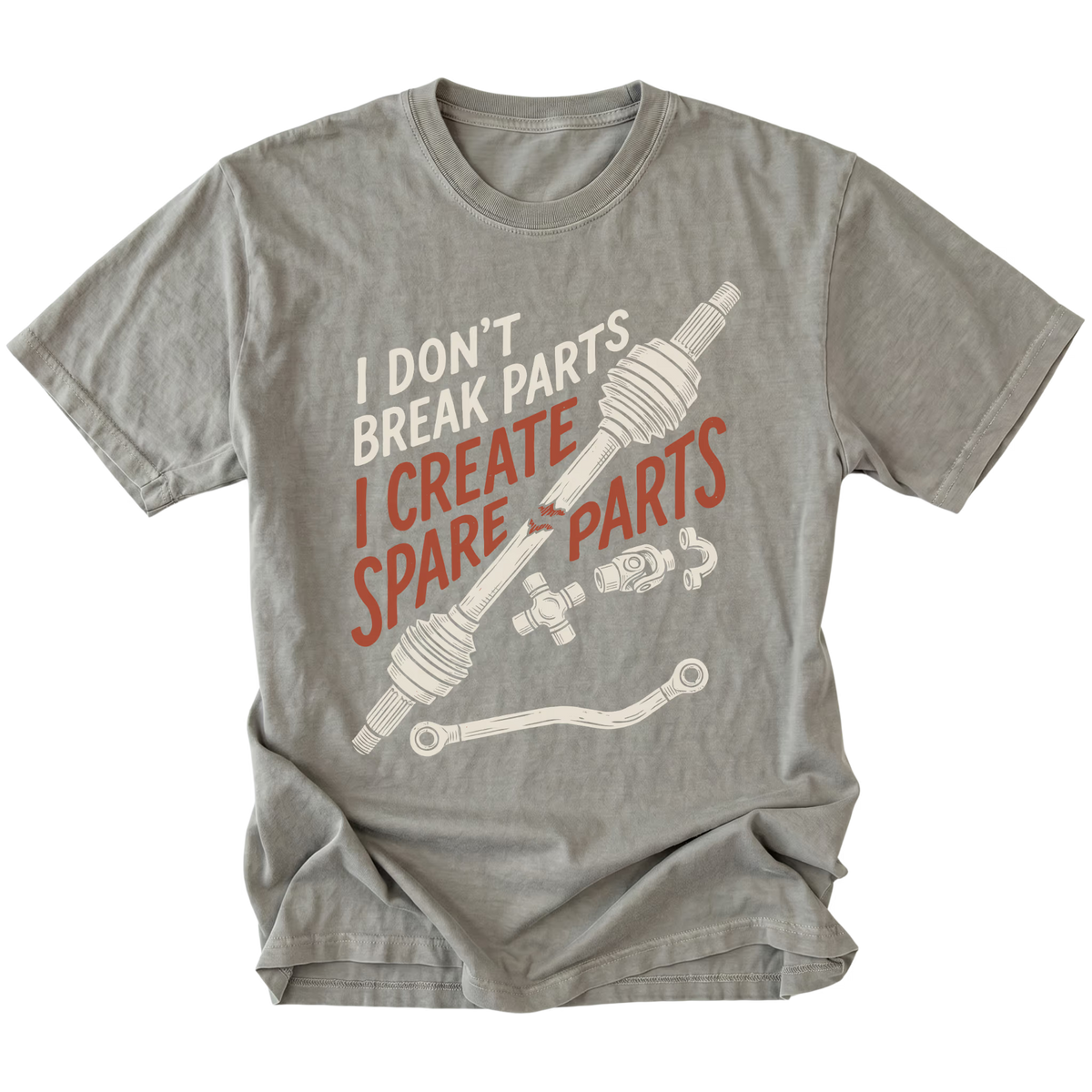 A heather gray short-sleeve t-shirt with a graphic print of a car axle and parts, featuring the text 'I DON'T BREAK PARTS I CREATE SPARE PARTS' in white and orange-red lettering, shown on a plain white background.