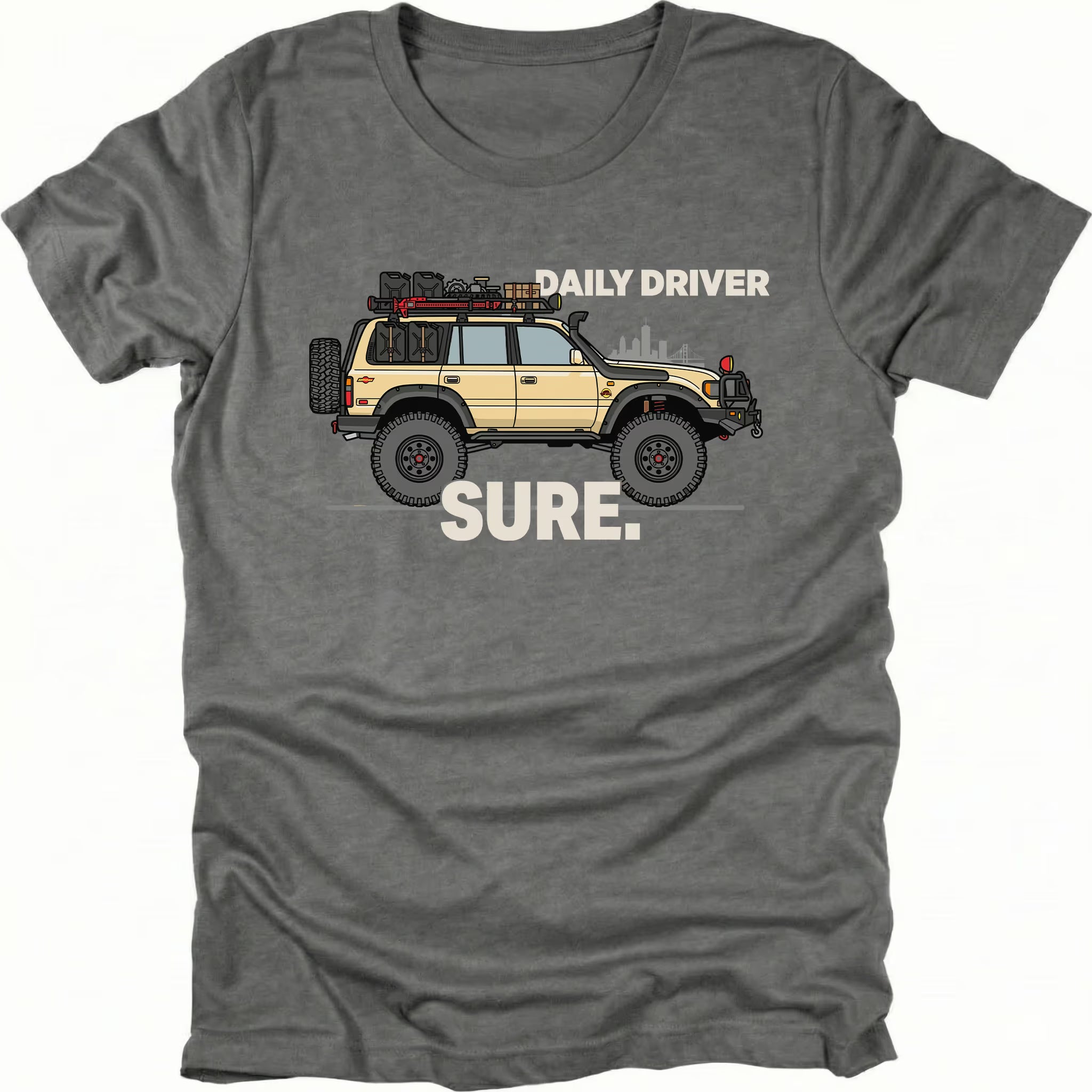 Grey t-shirt featuring a built off-road vehicle with daily driver sure text graphic shown from the front by Trail Snark.
