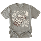 A gray crewneck t-shirt featuring a vintage-style graphic of a cassette deck with the text 'THE SKID PLATE KNOWS THE WAY' in cream and brown.