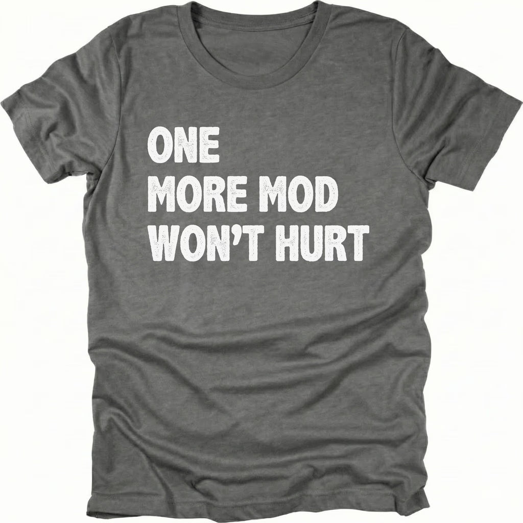Grey T-Shirt with bold white “One More Mod Won’t Hurt” text shown on front view by Trail Snark.