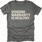 Grey t-shirt with bold text reading “Voiding Warranty Is Healthy” printed on the front.