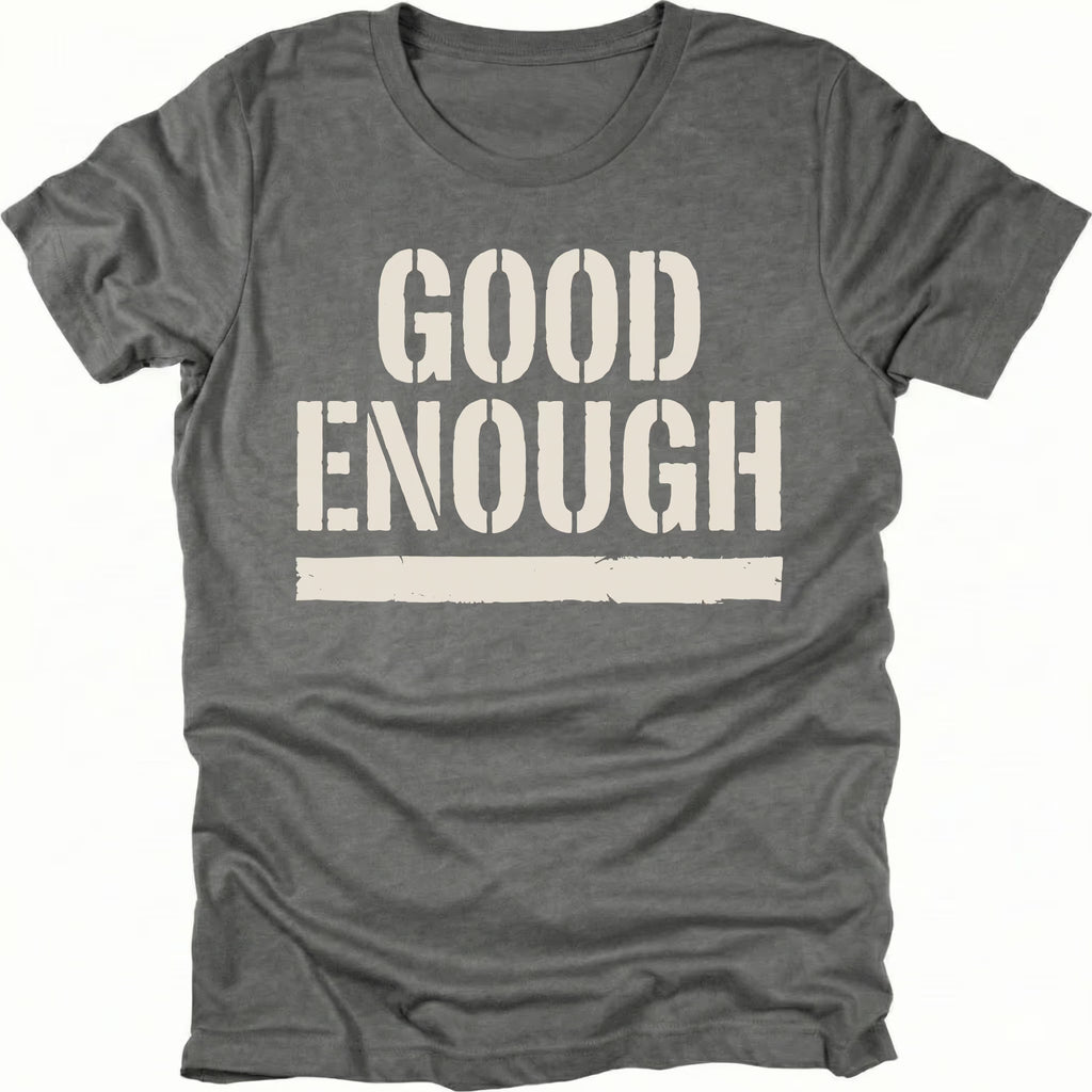 Grey t-shirt featuring bold distressed text reading Good Enough with an underline displayed on the front.