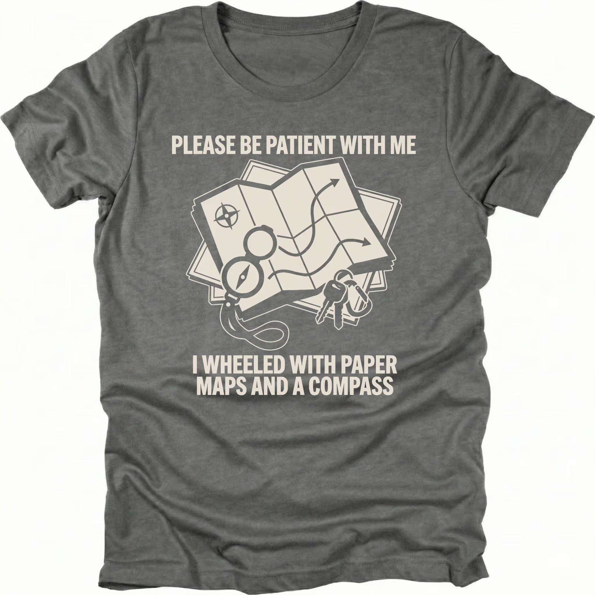 Grey T-Shirt with paper map and compass graphic reading “Please Be Patient With Me I Wheeled With Paper Maps And A Compass” shown on front view by Trail Snark.