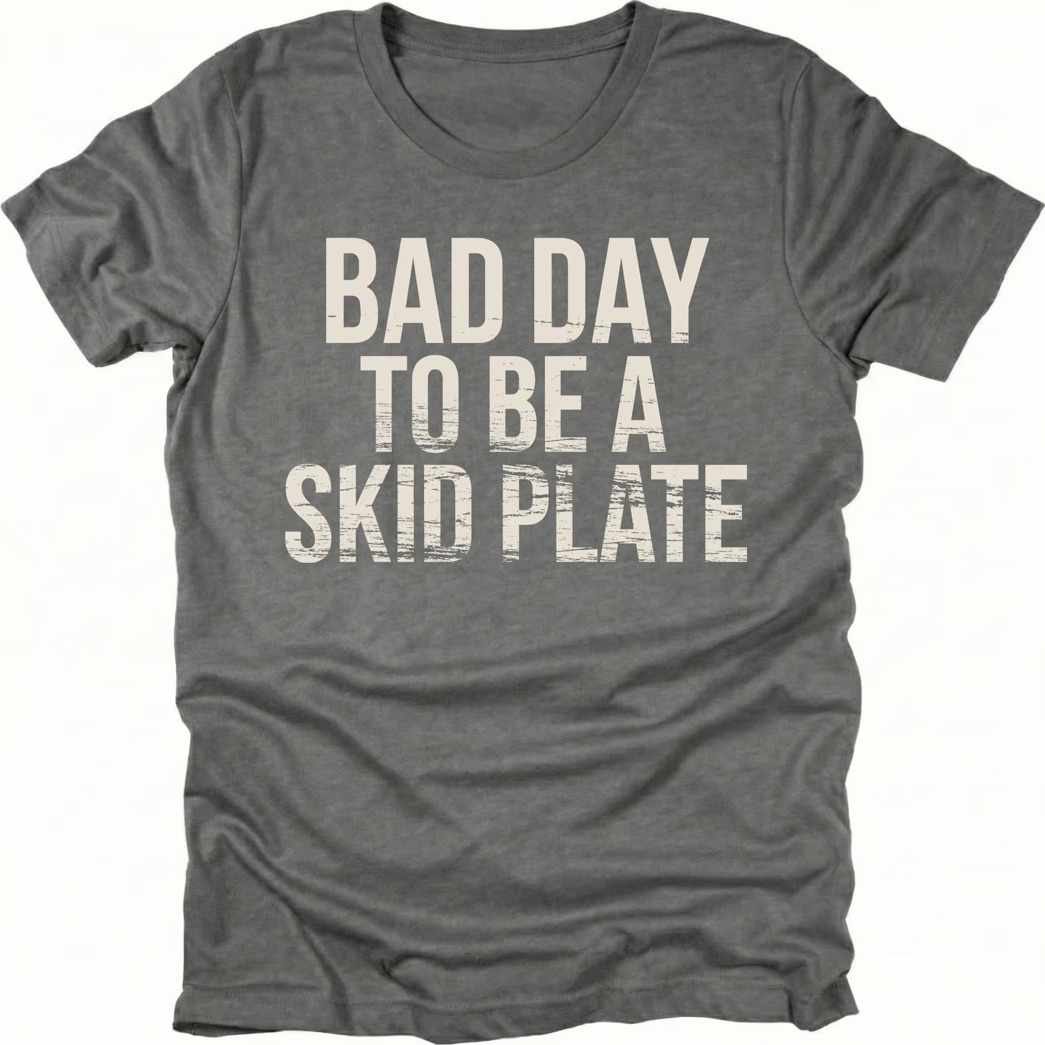 Grey t-shirt featuring bold bad day to be a skid plate text graphic shown from the front by Trail Snark.