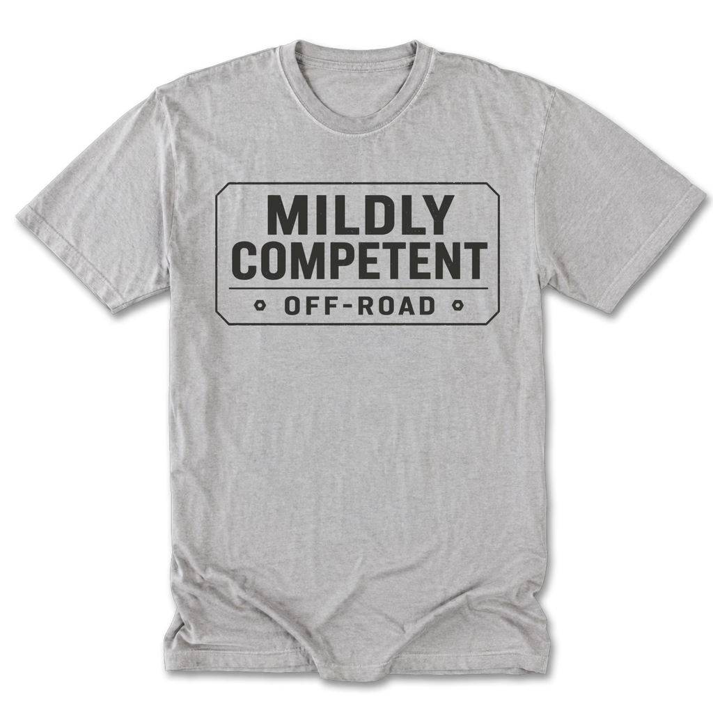 A light heather gray tall tee short-sleeve t-shirt with a black graphic print on the chest that reads 'MILDLY COMPETENT OFF-ROAD' inside a road-sign style border.