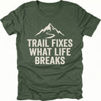 Moss t-shirt with the phrase “Trail Fixes What Life Breaks” beneath a mountain and winding trail graphic printed on the front.