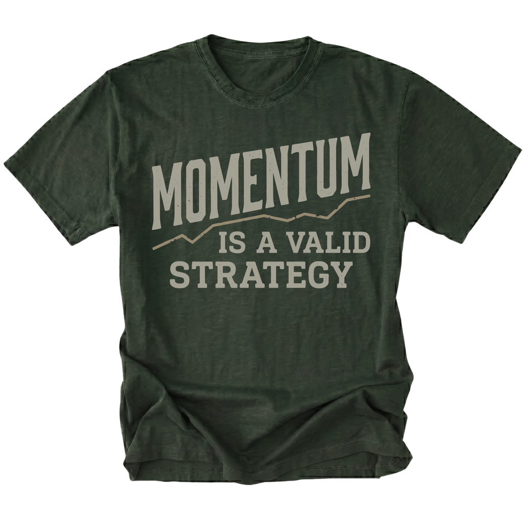 A moss green short-sleeve t-shirt with a distressed graphic print on the front that reads 'MOMENTUM IS A VALID STRATEGY' in a light beige/gray font, displayed against a solid white background.