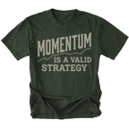 A moss green short-sleeve t-shirt with a distressed graphic print on the front that reads 'MOMENTUM IS A VALID STRATEGY' in a light beige/gray font, displayed against a solid white background.
