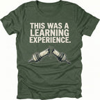 Moss t-shirt with text reading “This Was a Learning Experience” above an illustration of a broken axle or CV joint, shown on the front.